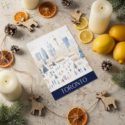 Christmas Card with 'Toronto' printed on it surrounded by candles, lemons, and decorative items on a textured surface.