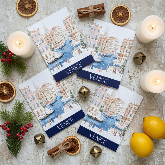 Venice-themed Christmas greeting cards with candles, oranges, and lemons on a textured surface