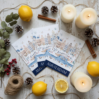 Amsterdam-themed greeting cards with lemons, candles, and pinecones on a wooden surface