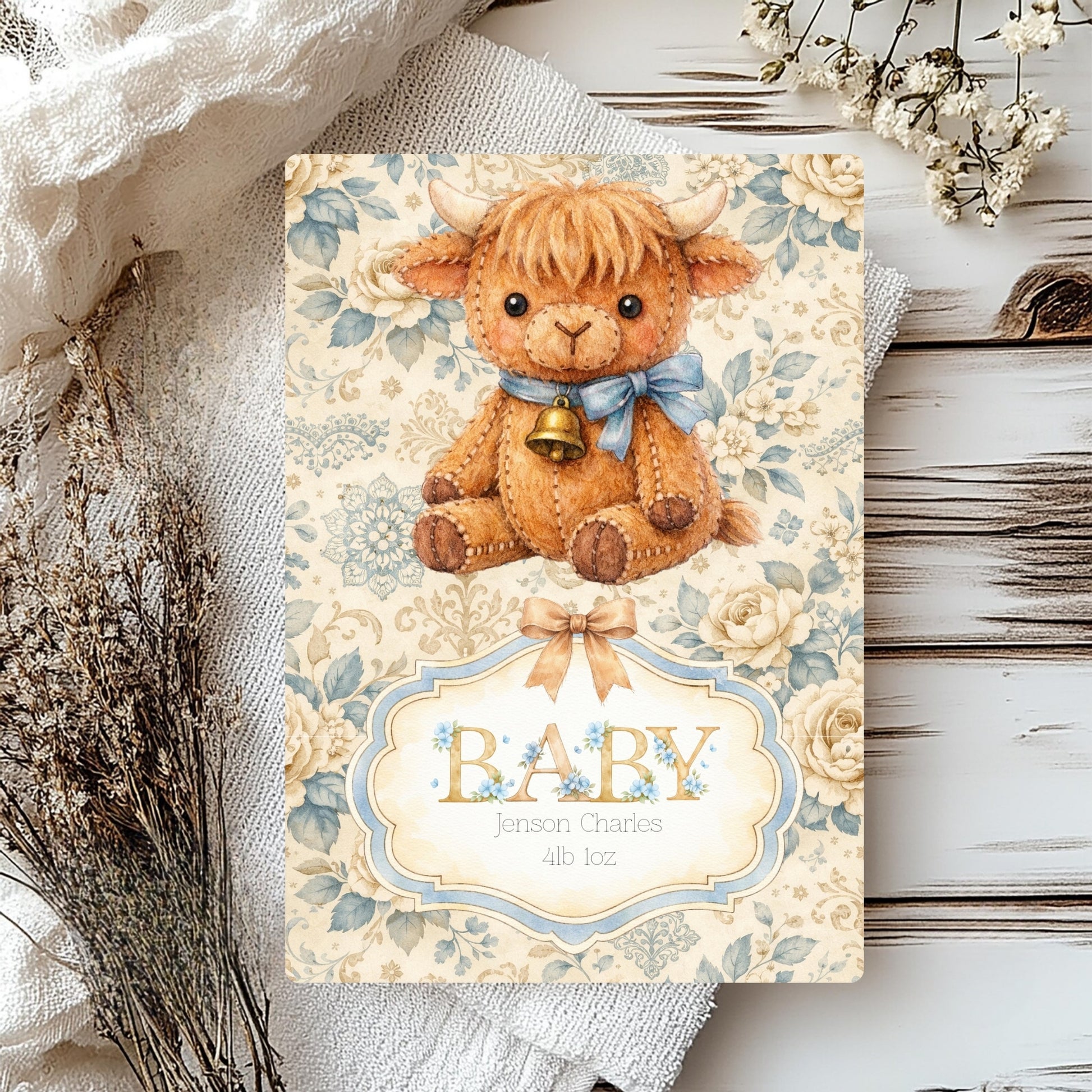 Highland cow new born baby card with personalised name and floral background on a rustic background