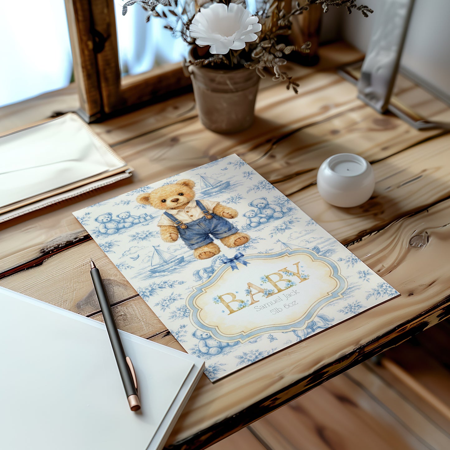 Baby card with teddy bear design on a wooden table